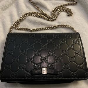 Gucci embossed black crossbody. Well loved but taken care of.